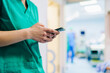 © Daniel Gonzalez/Stocksy - The hands of a doctor with a phone in the hospital