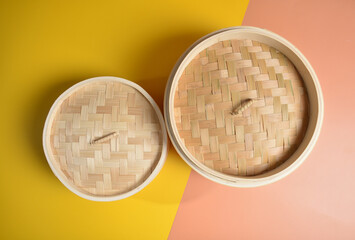 dim sum bamboo basket big and small for steamed food item in yellow background