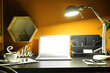 © Pixel-Shot - Modern workplace with laptop and glowing lamp near color wall