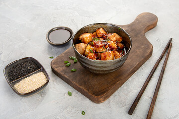 Wall Mural - Traditional homemade fried tofu with sesame on light gray background.