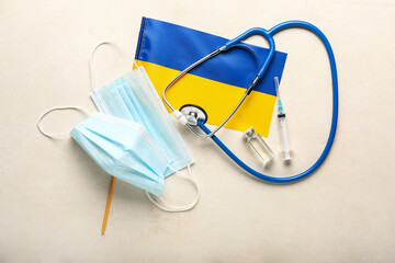 Doctor's supplies with flag of Ukraine on grey background