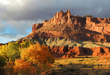 Wall Mural - the castle rock formation, changing leaves,  and fremont river in capitol reef national park, utah, in the fall