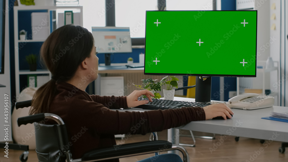 Disabled handicapped immobilized woman emplyee working on desktop ...
