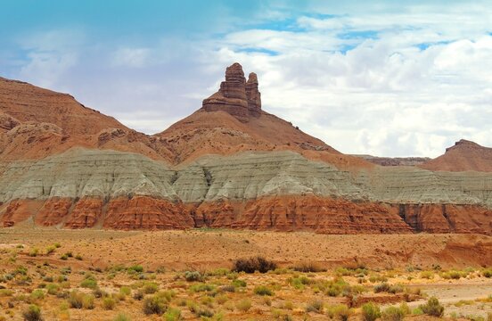  eroded spire red rock formation in the desert near goblin state park in  central utah 