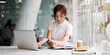 © itchaznong - portrait of busy business woman two hand cross working and sitting at workplace while with work in office.
