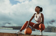 © Jacob Lund - Fitness woman relaxing with ball on rooftop