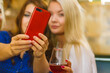 Girls in pub club taking self photo with phone