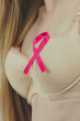 Woman chest in bra, pink cancer ribbon