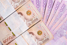 Much Banknote Of One Thousand Thai Baht Isolated On White Background. Thai Currency, Medium Of Exchange, And Stock Market Concept .