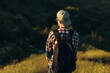 © Shopping King Louie - Young traveling man, handsome man in glasses and in a cap, with a backpack, walking in the forests of nature, hiking, active people