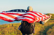 © Shopping King Louie - Traveler with America flag, man outdoors holding USA flag, American flag, Patriotic holiday