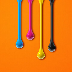 Wall Mural - cmyk ink drops on orange paper square background