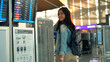 © Pixza - Asian traveler woman walking in airport terminal.