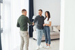 © standret - Salesman helps young couple in choosing an apartment. Conception of business and rent