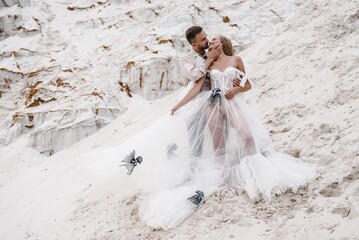 Beautiful wedding couple bride and groom at wedding day outdoors at ocean beach. Happy marriage couple o