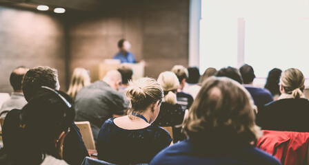 Speaker giving presentation on health care conference.