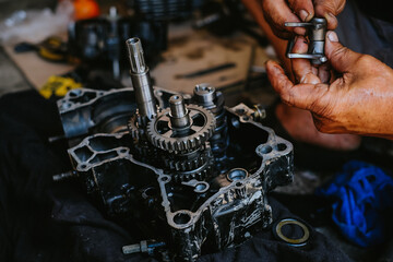 Assemble the motorcycle engine gear by a maintenance technician and check it.	