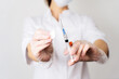 © Aboltin - Closeup female doctor hands in gloves syringe with needle full of drug and disinfection cotton swab
