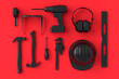 Top view of monochrome construction tools for repair on red and black