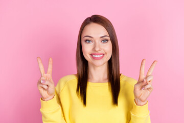 Wall Mural - Photo portrait girl smiling showing v-sign gesture smiling toothy isolated pastel pink color background