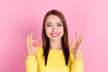 Wall Mural - Photo portrait girl showing okay sign smiling wearing casual clothes isolated pastel pink color background