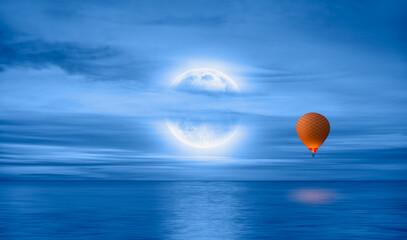 Hot air balloon flying over calm sea moon at night in the background full 