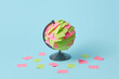 © Yaroslav Danylchenko/Stocksy - Colored adhesive paper stickers on globe