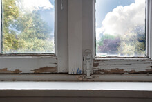 Old Wooden Window Frames With Rotting Wood And Cracked Peeling Paint, House Needs Renovation And New Frames