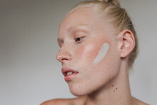 Freckled Model With White Clay Mask On Her Face