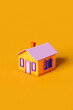 © Giada Canu/Stocksy - vertical image of a violet and orange house on orange background