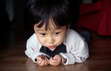 Cute Asian Chinese Little Boy Playing On The Floor At Home