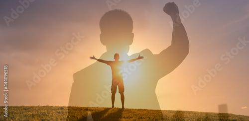 Strong confident man facing the sunset. People feeling inspire, and having inner strength concept.
