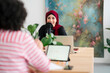 © Studio Marmellata/Stocksy - Happy Arab woman speaking to friend and recording podcast