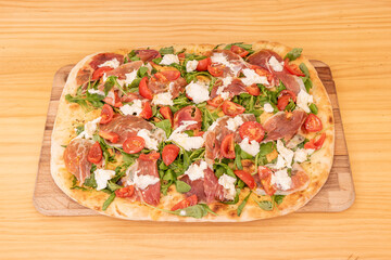 Wall Mural - Focaccia with buffalo cheese, arugula and Spanish serrano ham on wooden board