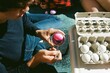 © Erin Brant/Stocksy - Teen boy coloring eggs