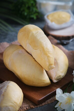 Close Up Of Fresh And Ripe Yellow Flesh Of Thai Durian On A Wooden Plate. It Is The Undisputed King Of Fruits In Southeast Asia. It Offers A Sweet, Creamy And Buttery Taste