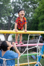 Asian Boy Playing In Outdoor Playground