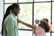 © Malquerida Studio/Stocksy - Child using virtual reality headset with her father