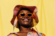 © Sergey Filimonov/Stocksy - Delighted black woman in sunglasses and sunhat