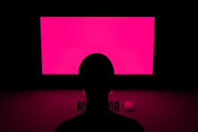 Gamer In Front Of Computer With Fuchsia Screen