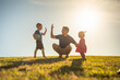 © kieferpix - Father playing with his children having fun at the park. Parenting and raising children concept.