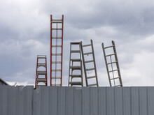 Ladders Against A Fence