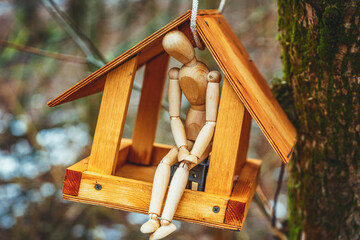 wooden toy man lives in a birdhouse