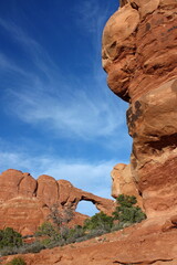 Wall Mural - eroded red rock arch on a sunny day in arches national park, utah