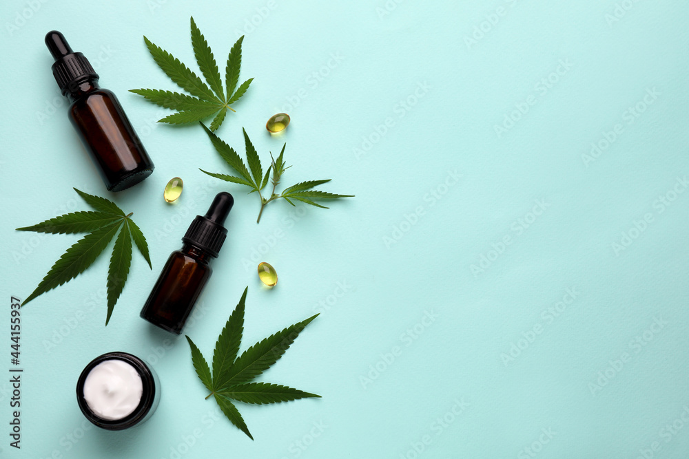 Flat lay composition with hemp leaves, CBD oil and THC tincture on light blue background, space for text - obrazy, fototapety, plakaty 