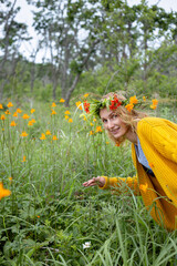 a girl in a wreath of flowers in a field of yellow flowers