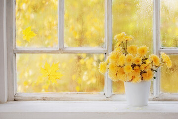 Wall Mural - chrysanthemums in  vase on  windowsill in autumn