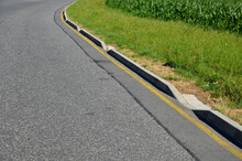 Installation Of Concrete Curbs With Gaps That Let Water Into The Park Into The Ditch, Where It Seeps Into The Grass And Does Not Drain Into The Sewer, Kerbside