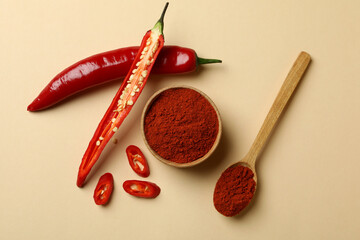 Poster - Red chili pepper and powder on beige background