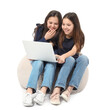 © Pixel-Shot - Cute twin girls using laptop on white background